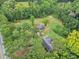 Aerial view of house and barn on tree-lined lot adjacent to the road at 1646 Highway 92 N, Fayetteville, GA 30214