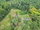 Aerial view of home and a barn on land surrounded by dense trees at 1646 Highway 92 N, Fayetteville, GA 30214