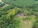Scenic aerial view of a residence surrounded by dense foliage, providing an oasis of privacy and natural beauty at 1646 Highway 92 N, Fayetteville, GA 30214