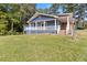 Backyard with a blue home and a spacious lawn leading to the deck at 1646 Highway 92 N, Fayetteville, GA 30214