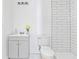 Bathroom featuring a white vanity, white toilet, and tiled walk-in shower, all with modern fixtures at 1646 Highway 92 N, Fayetteville, GA 30214