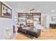Cozy bedroom features hardwood floors, a ceiling fan, and a comfortable chaise lounge at 1646 Highway 92 N, Fayetteville, GA 30214