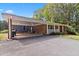 Single story brick home featuring a carport and white porch railing at 1646 Highway 92 N, Fayetteville, GA 30214