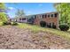 Exterior of a brick house with mature trees on a sloping lot at 1646 Highway 92 N, Fayetteville, GA 30214