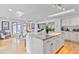 Bright kitchen with an island featuring granite countertops, seating and access to the dining and living areas at 1646 Highway 92 N, Fayetteville, GA 30214