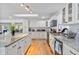 Bright kitchen features an island with granite countertops, white cabinets and access to the living room at 1646 Highway 92 N, Fayetteville, GA 30214