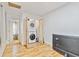 Hallway featuring a stacked washer and dryer inside a closet with access to other rooms, plus a TV on the wall at 1646 Highway 92 N, Fayetteville, GA 30214