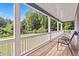 Covered front porch area with seating and views of the lush green yard at 1646 Highway 92 N, Fayetteville, GA 30214