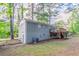 Backyard featuring a deck, staircase, fenced yard, and two-story grey house at 2922 Carriage Ln, Atlanta, GA 30349