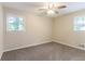 Bright bedroom with neutral walls, carpet, and two windows offering lots of natural light at 2922 Carriage Ln, Atlanta, GA 30349
