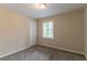 Cozy bedroom features a neutral color scheme, plush carpet, and natural light from the window at 2922 Carriage Ln, Atlanta, GA 30349