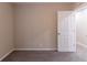 Cozy bedroom with neutral walls, plush carpet, and an entrance to another room at 2922 Carriage Ln, Atlanta, GA 30349