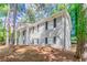 An angled shot of a gray brick home with black shutters and a well-maintained yard at 2922 Carriage Ln, Atlanta, GA 30349