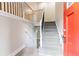 Entryway featuring an updated staircase with iron balusters and a stylish, bright red front door at 2922 Carriage Ln, Atlanta, GA 30349