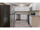 Well-lit kitchen features stainless steel appliances, white cabinets, and granite countertops at 2922 Carriage Ln, Atlanta, GA 30349