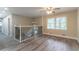 Upstairs landing with views of hardwood floors, railing, and a bright window at 2922 Carriage Ln, Atlanta, GA 30349