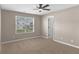 This empty bedroom is bathed in natural light and has a ceiling fan at 7120 Oakley Ct, Union City, GA 30291