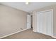 A bedroom with plush carpet features a closet with paneled doors at 7120 Oakley Ct, Union City, GA 30291