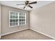 This bedroom features plush carpet, a ceiling fan, and a window at 7120 Oakley Ct, Union City, GA 30291