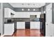 Modern kitchen with white cabinets, black appliances, and a stylish mosaic backsplash at 7120 Oakley Ct, Union City, GA 30291