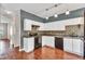 This kitchen features white cabinets, a mosaic backsplash, and sleek black appliances at 7120 Oakley Ct, Union City, GA 30291