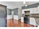 The kitchen features an open layout with black appliances and views to the dining area at 7120 Oakley Ct, Union City, GA 30291
