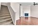 Bright living room featuring a cozy fireplace, and staircase with beautiful hardwood floors at 7120 Oakley Ct, Union City, GA 30291