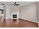 Spacious living room featuring hardwood floors, a fireplace, and a ceiling fan at 7120 Oakley Ct, Union City, GA 30291