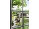 View through a window, showing the manicured garden and backyard exterior at 138 Garland Ave, Decatur, GA 30030