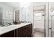 Bathroom featuring a double vanity with modern fixtures and a separate tub/shower at 138 Garland Ave, Decatur, GA 30030