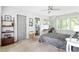 Bedroom with a ceiling fan, carpet floors, and a view into the bathroom at 138 Garland Ave, Decatur, GA 30030