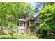 Charming two-story home featuring a stone foundation, manicured lawn, and lush landscaping at 138 Garland Ave, Decatur, GA 30030