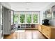 Bright home office featuring built-in shelving, hardwood floors, and large windows with a lush green view at 138 Garland Ave, Decatur, GA 30030