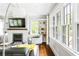 Bright living room with a fireplace, a large television, and many windows overlooking the yard at 138 Garland Ave, Decatur, GA 30030