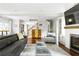 Bright living room with a fireplace, a large television, and modern decor at 138 Garland Ave, Decatur, GA 30030