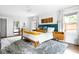Spacious main bedroom featuring a king-size bed, plush rug, and large windows with bright natural light at 138 Garland Ave, Decatur, GA 30030