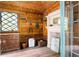 Rustic shed interior with wood paneling, a diamond pane window, and antique furnishings, evoking charm at 138 Garland Ave, Decatur, GA 30030