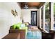 Inviting sunroom with bright green sofa, rattan furniture, and natural light from large windows at 138 Garland Ave, Decatur, GA 30030