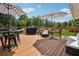 Back deck with outdoor dining and lounging area under striped umbrellas at 1932 Brenda Dr, Austell, GA 30168