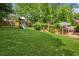 Expansive backyard with lush grass, playground, and deck with furnishings at 1932 Brenda Dr, Austell, GA 30168
