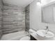 Cozy bathroom with stone tiled shower and tub and a vessel sink with chrome faucet at 1932 Brenda Dr, Austell, GA 30168