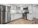 Cozy kitchen with stainless steel appliances, white cabinets, and wood floors at 1932 Brenda Dr, Austell, GA 30168