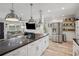 Open-concept kitchen flowing into a bright living room, featuring stainless steel appliances and barstool seating at 1932 Brenda Dr, Austell, GA 30168