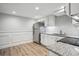Cozy kitchen with stainless steel appliances, white cabinets, and wood floors at 1932 Brenda Dr, Austell, GA 30168