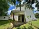 Exterior view of the backyard with a covered patio and fenced lawn at 2711 Teal Landing Dr, Morrow, GA 30260