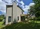 Exterior shot showcasing backyard with a covered patio, green lawn, and mature trees enhancing outdoor living at 2711 Teal Landing Dr, Morrow, GA 30260