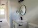 Bathroom vanity with black finishes, modern sink and mirror, and neutral color scheme at 2711 Teal Landing Dr, Morrow, GA 30260
