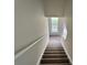 Carpeted stairway leading upstairs with neutral paint and natural light from a window at 2711 Teal Landing Dr, Morrow, GA 30260