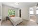 Bright bedroom with a daybed and a hallway bathroom, filled with natural light from a large window at 5652 Harbormist Dr, Powder Springs, GA 30127