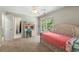 Bedroom features a ceiling fan, a light wood-framed bed, a desk, and large windows for natural light at 5652 Harbormist Dr, Powder Springs, GA 30127